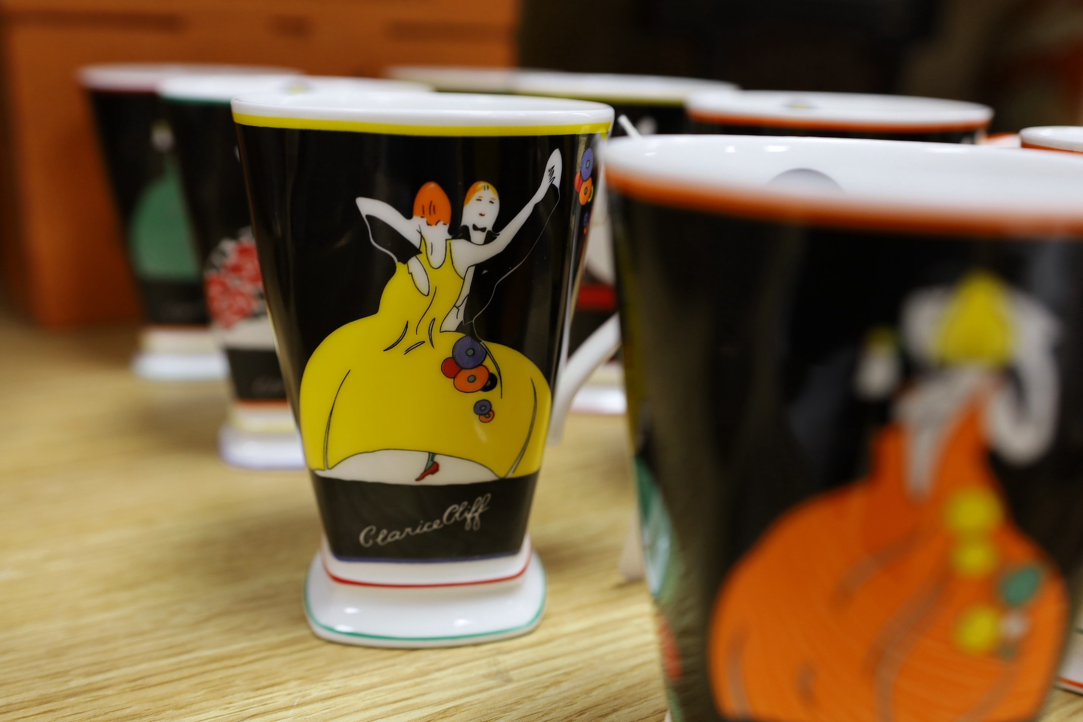 Eight Clarice Cliff limited edition ‘Age of Jazz’ mugs - Charleston, Fascinating Rhythm, Strike Up The Band, Putting On The Ritz, High Society, On The Town, Cheek To Cheek and Shall We Dance. 12cm tall, boxed.